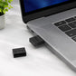 Black 8BitDo USB wireless Bluetooth receiver plugged into a laptop USB port.