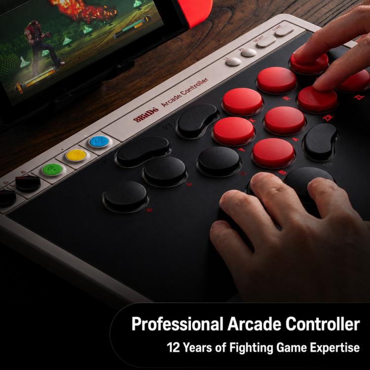 Arcade-style controller with red buttons, black sticks, and hand-held gaming controls