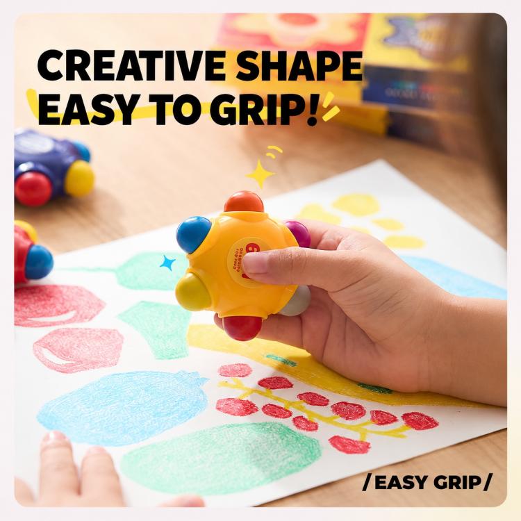 Hand gripping a yellow flower-shaped pocket crayon over colorful drawing sheets