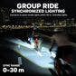 Bike front light casting synchronized group lighting across the roadway at night