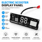 Electric scooter display panel with LCD screen, control buttons, and red/black cable