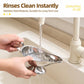 Stainless steel sauce boat being rinsed under a running kitchen faucet