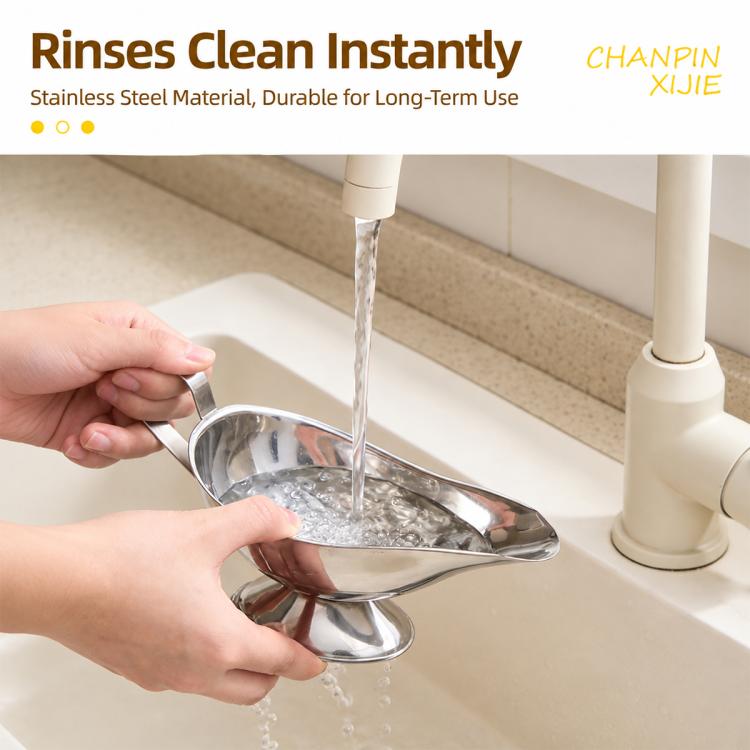 Stainless steel sauce boat being rinsed under a running kitchen faucet