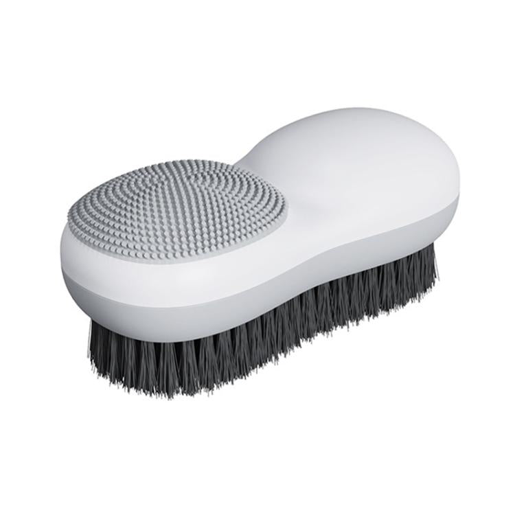 White double-sided laundry brush with gray textured pad and dark bristle brush side
