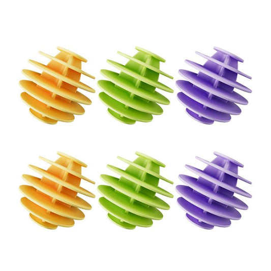 Set of multicolor TPR laundry cleaning balls, ridged spiral shape in yellow, green, and purple.