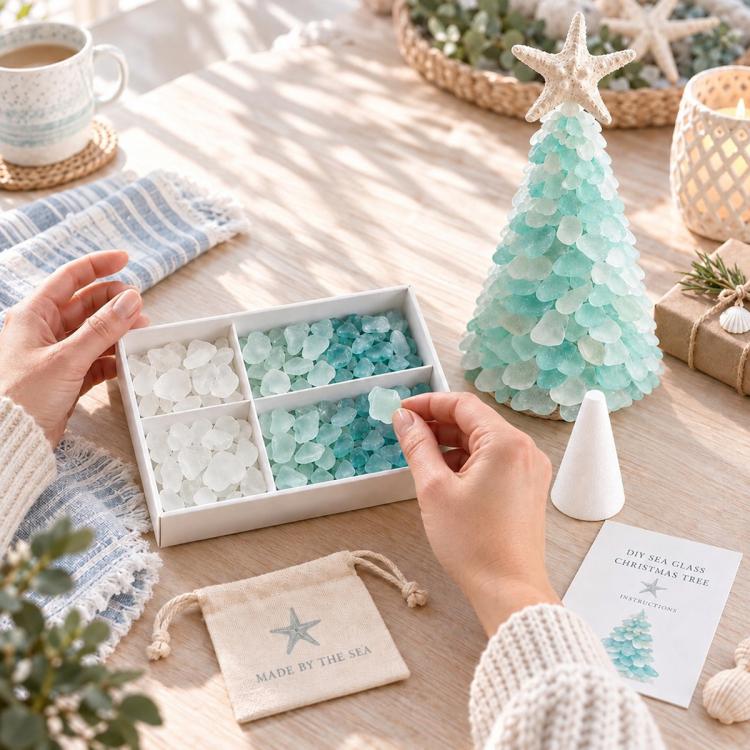 Hands placing sea glass pieces into kit tray for a layered Christmas tree craft