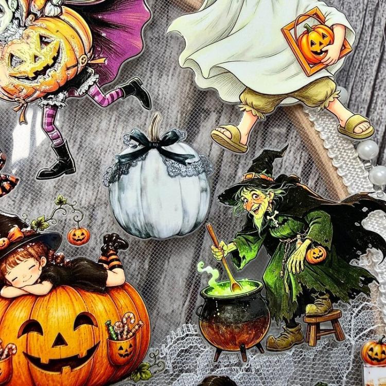 Close-up Halloween sticker sheet details with ghost, pumpkin, witch, and cauldron