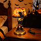 Halloween table lamp with orange stained glass shade and black cat figurine, ornate base.