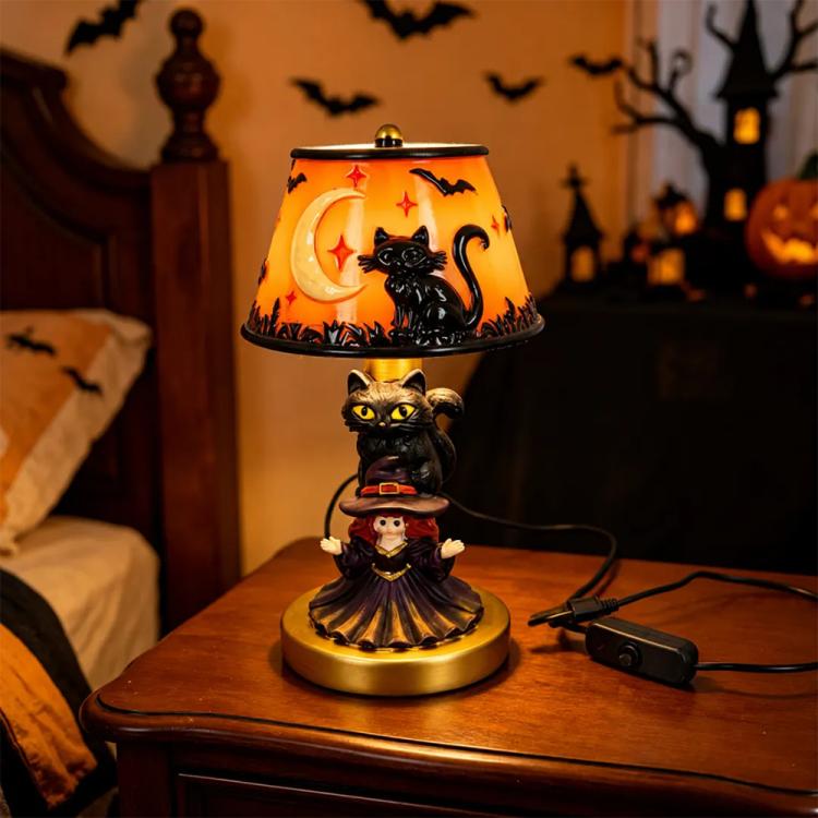 Halloween table lamp with orange stained glass shade and black cat figurine, ornate base.