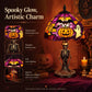 Halloween stained glass table lamp with purple shade, jack-o'-lantern and ghost, detailed skeleton base.