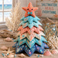 Patchwork Christmas tree ornament with orange starfish topper and layered ocean fabric