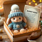Mini bunny hug plush with blue knit beanie and flower sweater, in a gift box