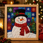 Framed Christmas fabric art kit featuring a snowman in a hat with colorful patch background