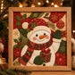 Framed Christmas fabric art kit featuring a smiling snowman holding a gift and scarf