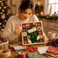 Person holding framed Christmas fabric art, adding fabric pieces with a purple tool