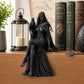 Black raven goddess desktop ornament with raven perched nearby, long draped robe details