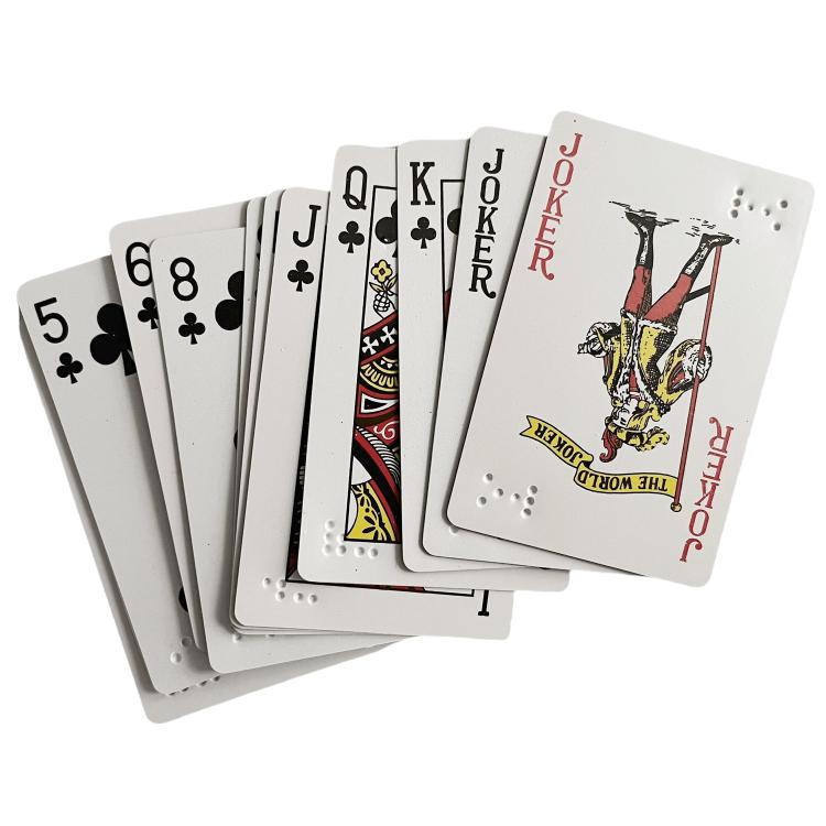 Stack of gray plastic playing cards with red/black faces and raised braille dots on back