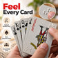Close-up of gray playing cards showing raised braille dots and red/black Joker face