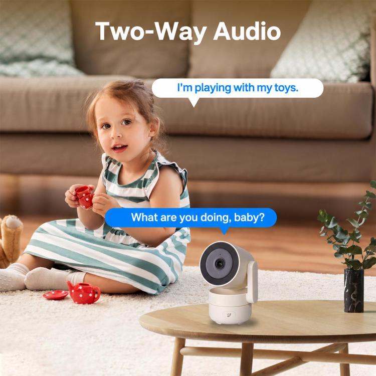 White indoor smart security camera on a table with a child and two-way audio prompts.