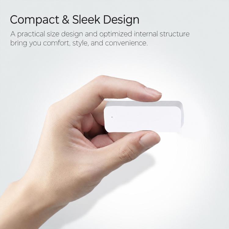 Compact white wireless magnetic door and window sensor held in two hands