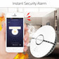 White round smoke detector alarm with black center ring and mounting tabs