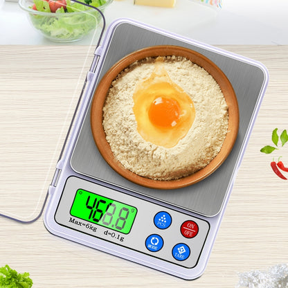 Portable digital kitchen scale with stainless pan, green LCD reading 4.0 g
