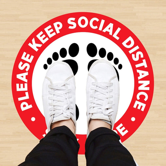 Social distance floor sticker with red ring text and black foot icons, 24 cm round