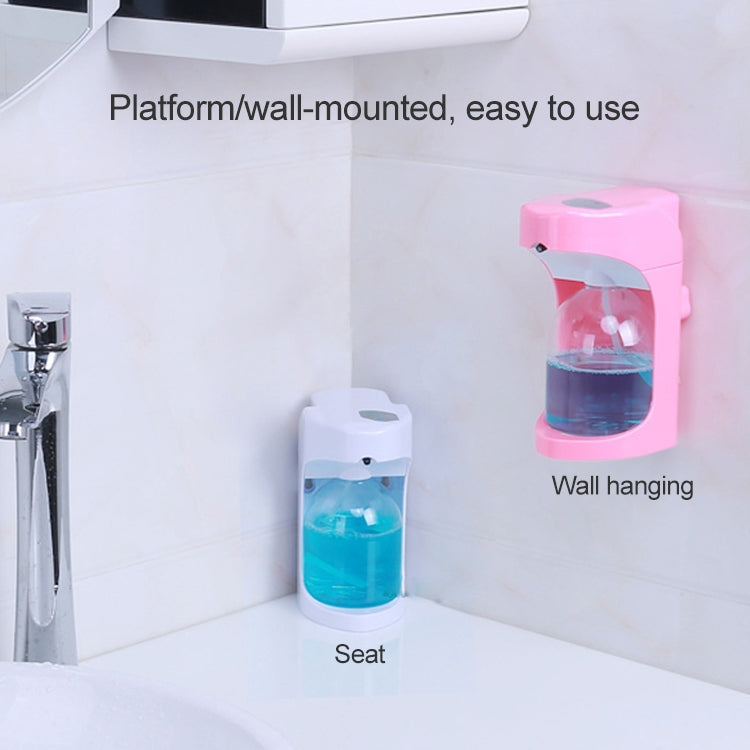 Pink wall-mounted automatic soap dispenser with blue liquid reservoir
