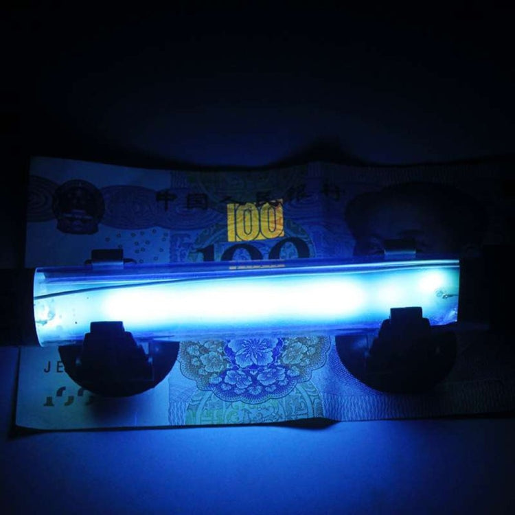 UV germicidal sterilization lamp with glowing blue tube inside fish tank