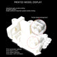 White 3D printed mechanical parts on a desktop 3D printer bed