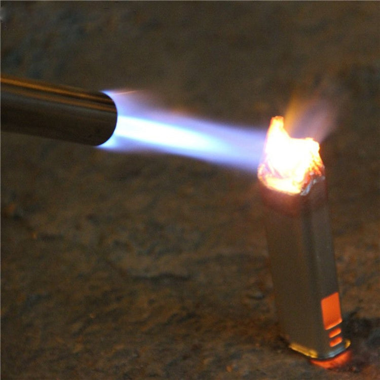 Gas blow torch with blue flame and orange tip aimed at a metal surface
