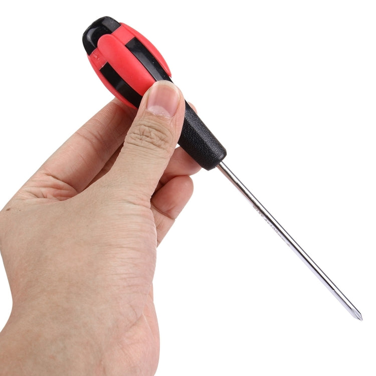 Cross screwdriver held in hand, red-and-black handle with chrome cross bit