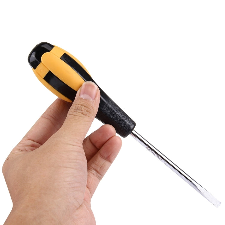 Slot screwdriver held in hand, orange and black handle with long flat blade tip