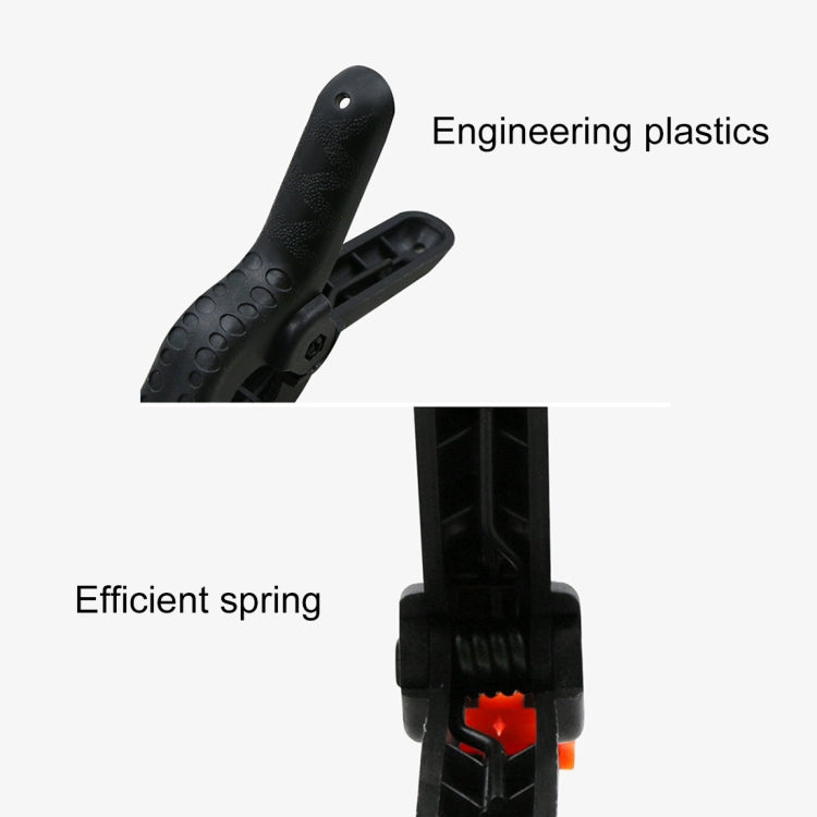 Black engineering-plastics spring clamp with orange spring mechanism detail