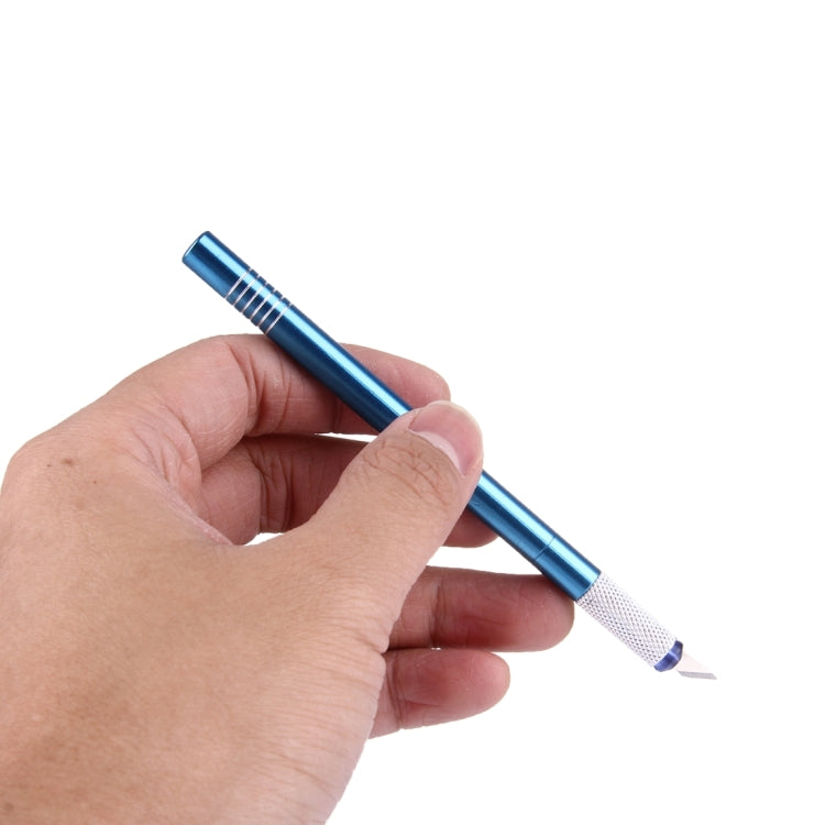 Precision knife held in hand, blue handle with metal pointed blade tip