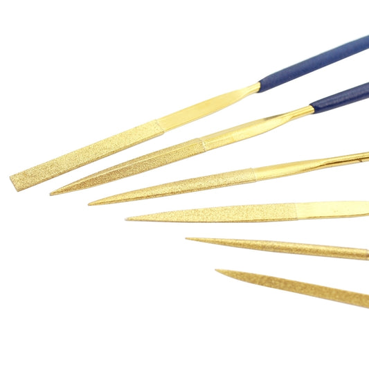 Gold needle files with blue handles, four tools laid diagonally