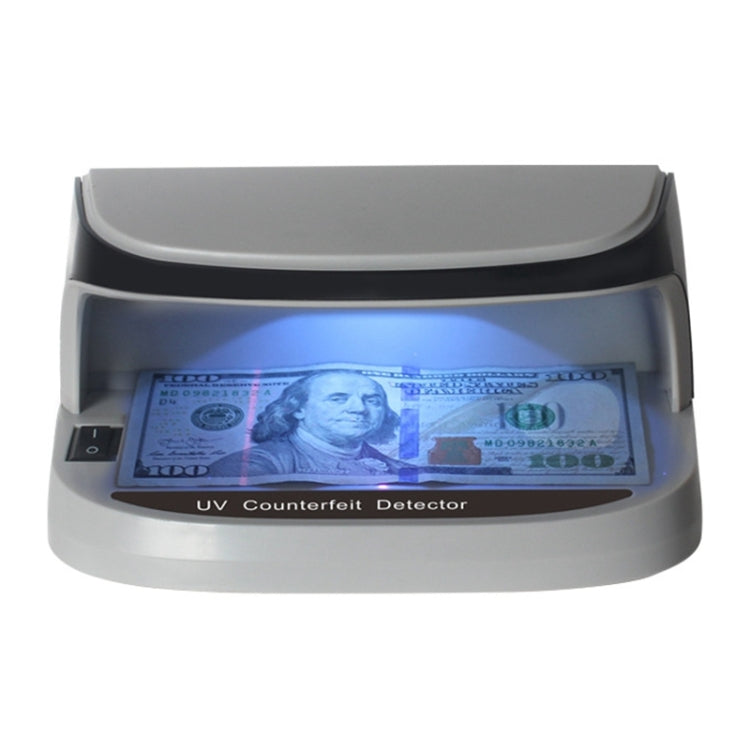 LED UV money detector with viewing window, blue UV glow over a banknote