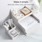 Grey-white desk organizer storage box with drawers holding stationery and papers
