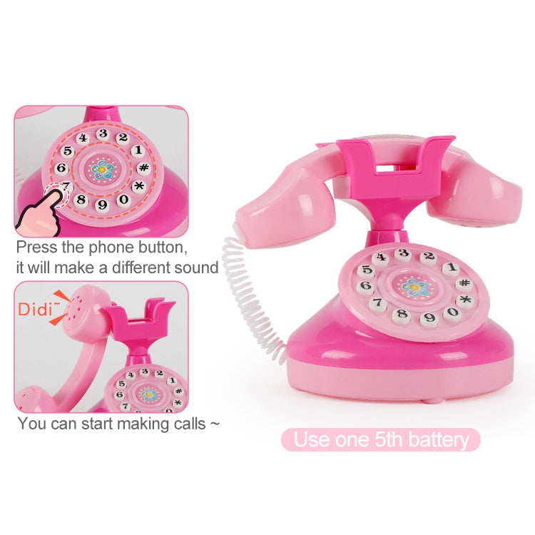 Pink toy telephone with handset and circular numbered dial on round base