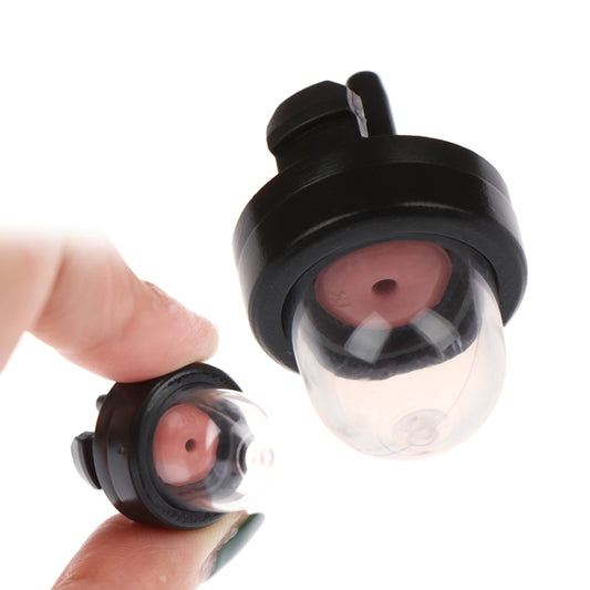 Carburetor primer bulb with clear bulb, red valve, and black housing