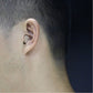Beige in-ear hearing aid worn behind ear on model