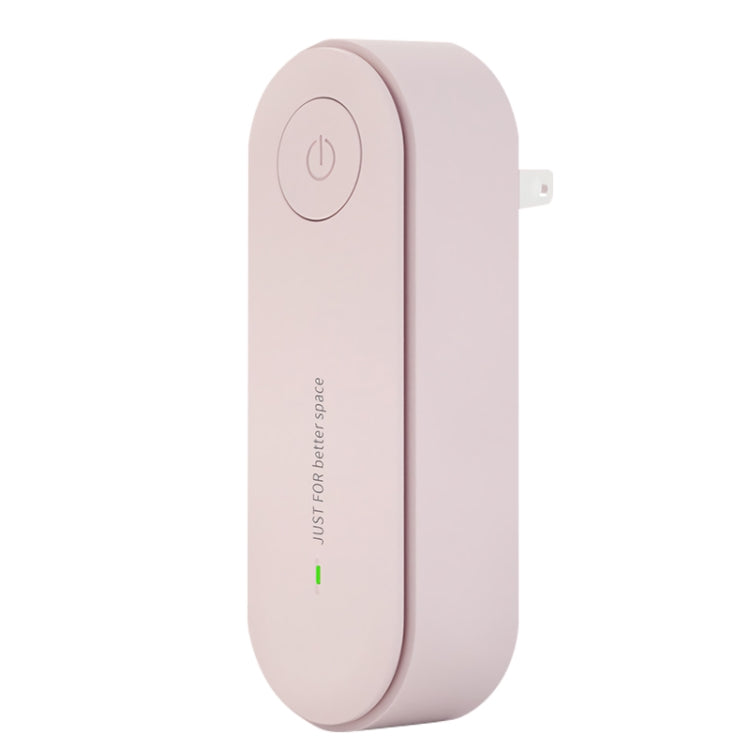 Mini ultrasonic deodorizer device, pink side view with power button and wall plug