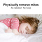 Child sleeping on a bed with a pink star-pattern blanket