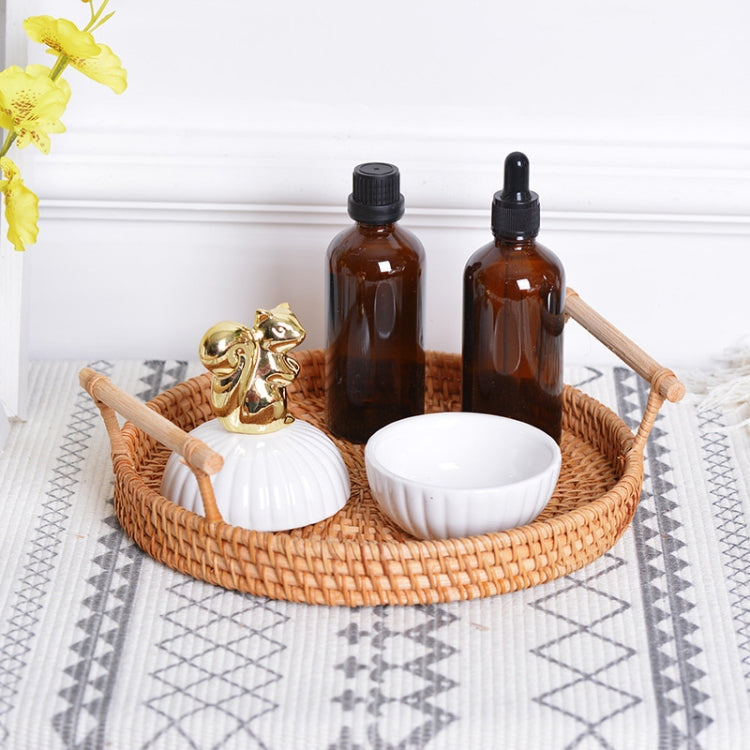 Braided snack basket tray with wooden handles holding amber bottles and white ribbed bowls