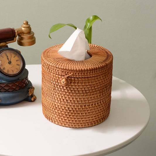 Round woven rattan tissue storage box with top opening holding white tissues