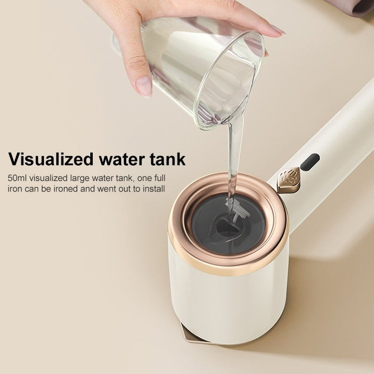 Handheld steamer with open water tank and clear water being poured into the top