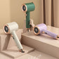 Handheld garment steamers in green, purple, and white with round steam heads