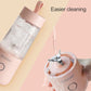 Pink portable juicer blender bottle shown with water rinsing the cup
