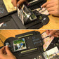 Hands placing photo cards into a black photo explosion album with chalk-style writing panels