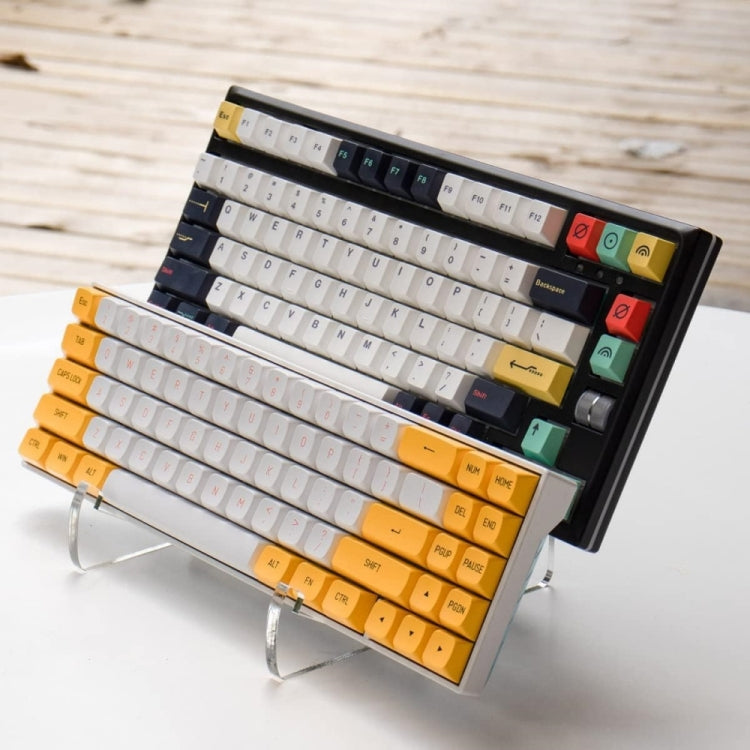 Transparent acrylic keyboard stand with black backing and yellow-orange keycaps